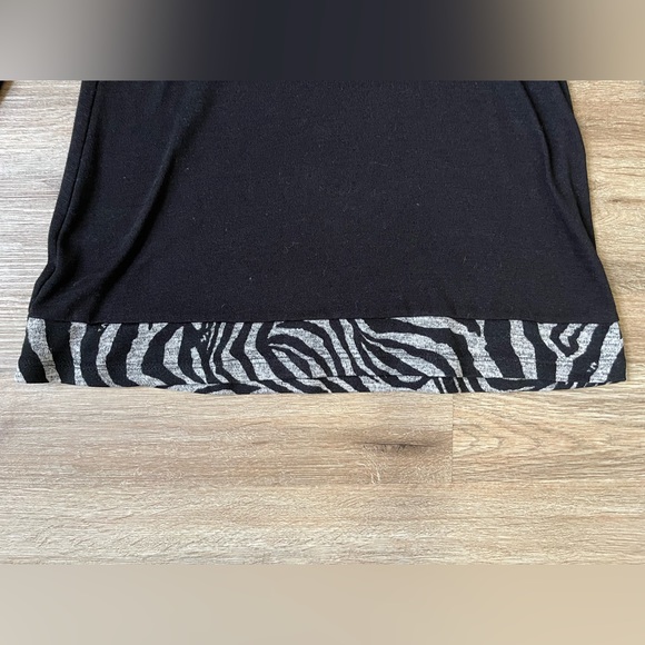 Size is 8. Solid black long sleeve shirt with design. - Picture 3 of 4